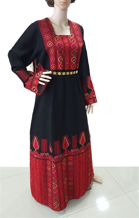 a mannequin dressed in a long dress with red and black designs on it