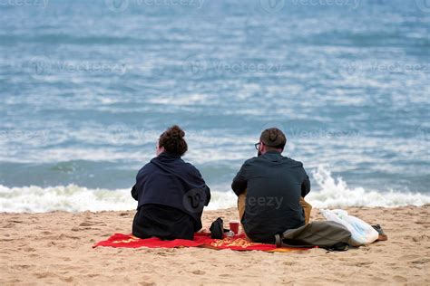 romantic picnic love couple sitting on sea beach candid couple talking about romantic