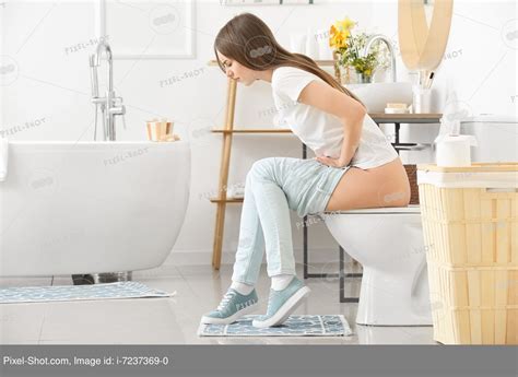 Babe Woman With Hemorrhoids Sitting On Toilet Bowl In Bathroom Stock Photography Agency