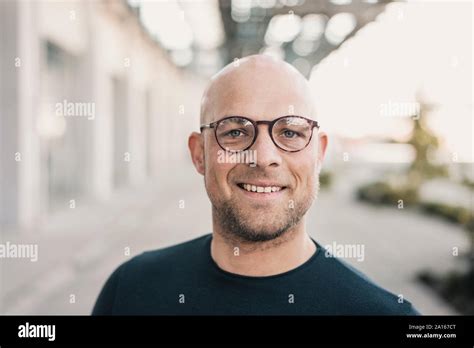 Portrait Of Smiling Bald Man Wearing Glasses Stock Photo Alamy