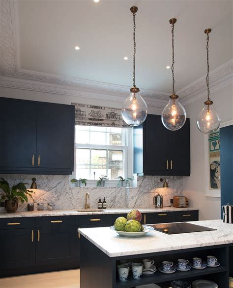 Marble Kitchen Dark Blue Cabinets Brass Hardware Glass And Brass Light Pendants Kitchen