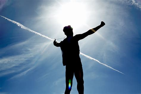 Silhouette Of Man Rejoicing Achievement Raised The Hands Stock Photo