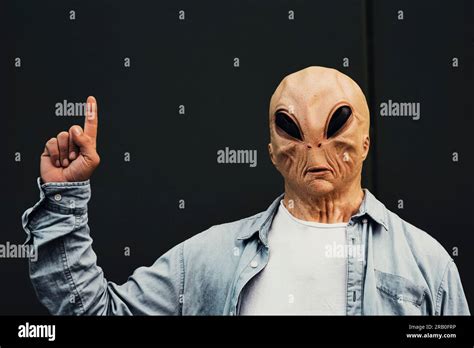 Ufo Alien Portrait Standing Against A Black Wall Background And