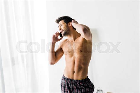 Shirtless Man Talking On Smartphone In Bedroom Stock Image Colourbox