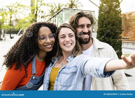 Diverse Group Of Three Friends Taking A Selfie In The Street Cheerful