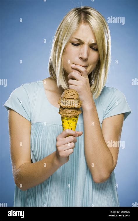 Woman Eating Ice Cream Out Of A Tape Measure Cone Stock Photo Alamy