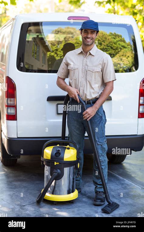 Portrait Of Happy Janitor With Vacuum Cleaner Stock Photo Alamy