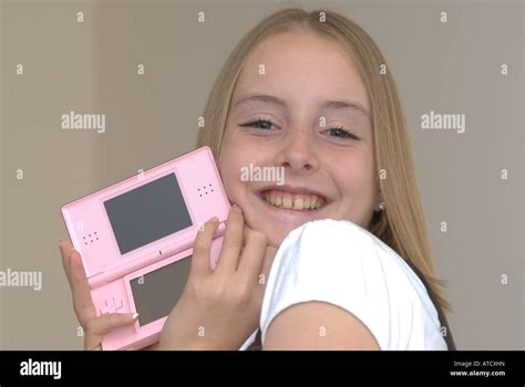 Young Girl Holding A Nintendo Ds Lite Game Console Uk Stock Photo Alamy