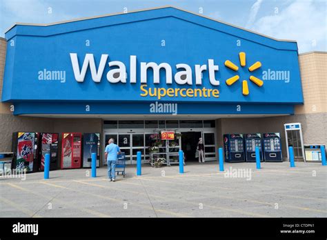 Exterior View Of Walmart Supercentre Store With Shoppers Outside Stock