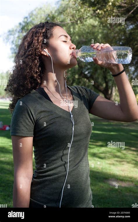 Sporty Girl Doing Exercise And Drinking Water Stock Photo Alamy