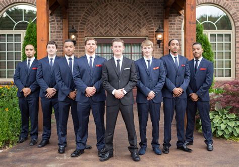 Groomsmen In Navy Blue Suits To Match Bridesmaid Groom In Classic