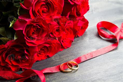 Valentines Day Red Roses And Wedding Ring A Wooden Background 1372695