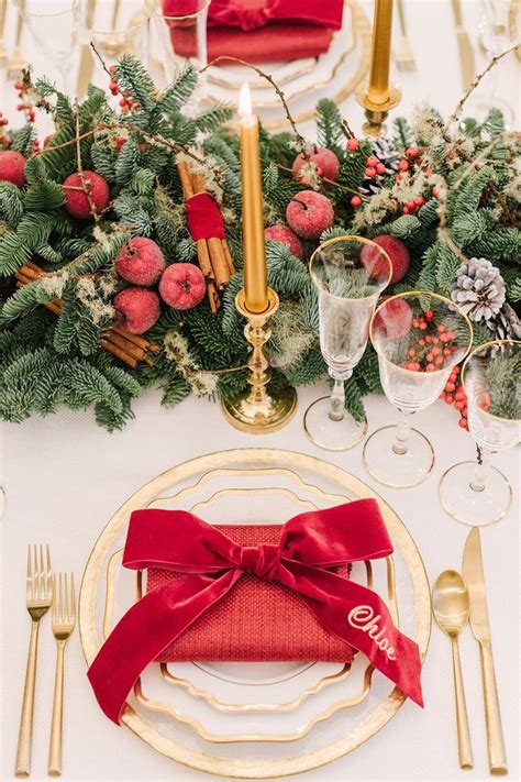 a place setting with red napkins silverware and christmas decorations