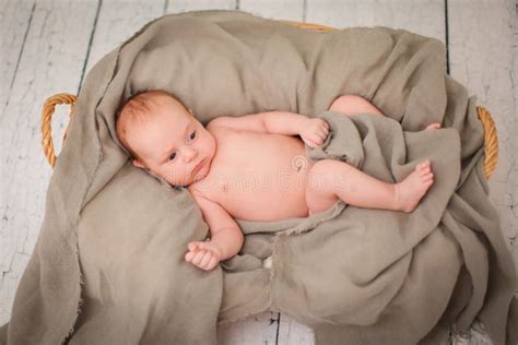 Newborn Baby Is Lying In Wicker Basket Basket On White Wooden Background Newborn Photo Shoot