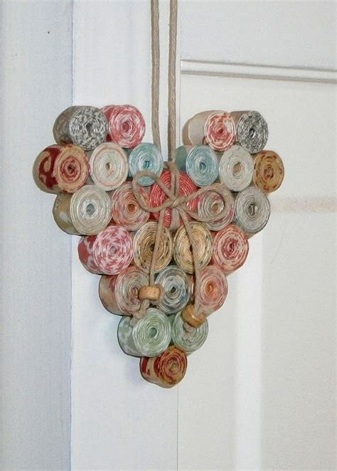 A Heart Shaped Decoration Made Out Of Rolled Up Yarn And Twine Hanging