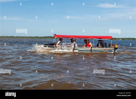 A Small Motor Boat With Tourists Visiting The Meeting Of The Waters Of