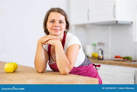 Portrait Of Positive Girl Housewife In Apron Standing At Kitchen Stock Image Image Of Cooking