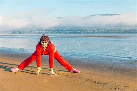 Beautiful Mature Woman Doing Gymnastics On A Sandy Beach On A