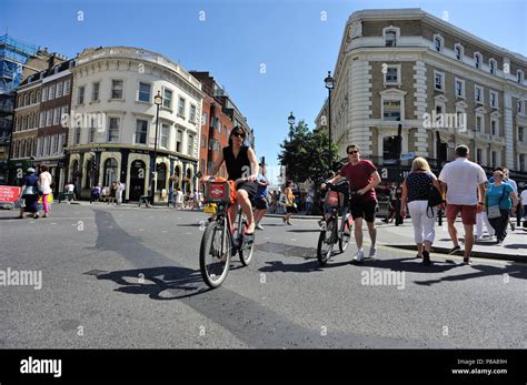 Cyclists Crossing Road Cambridge Circus London England Uk Stock