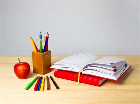 Back To School Background With Books Pencils And Apple Over Wooden