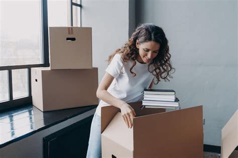 Premium Photo Happy Woman Packing Carton Box With Things Relocating