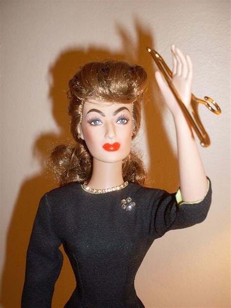 A Doll With Scissors In Her Hand And A Black Dress On The Other Side