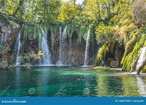 Beautiful Turquoise Waterfalls From Rocky Cliff In Forest At Plitvice