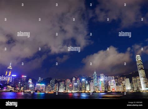 View Across Victoria Harbour Of High Rise Buildings At Night In Hong