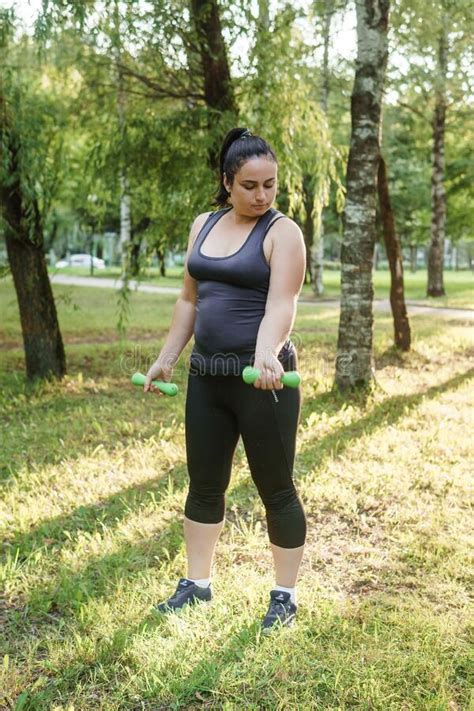 A Charming Brunette Woman Plus Size Body Positive Practices Sports In
