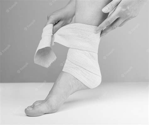 Premium Photo Woman Wrapping Compression Bandage Around Sprained