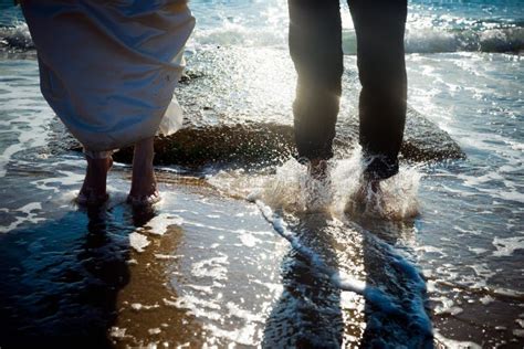 Couple Of Heterosexual Couple Having Fun Splashing Waves On The Beach Stock Image Image Of