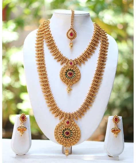 Indian gold earrings are quite a versatile piece of ornament and can go with every outfit, be it the indian or western. One Gram Gold Plated Temple Mango Design Long Short ...