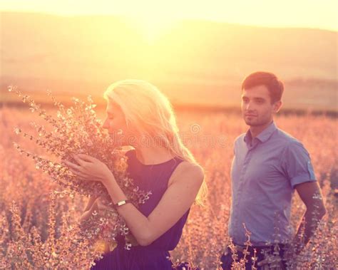 Beautiful Landscape And Couple In Love With Flowers On Sunset Stock