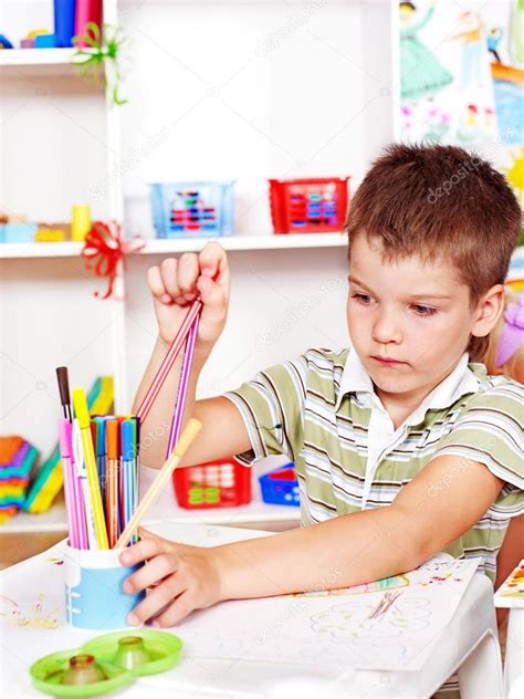 Child Painting At Easel Stock Photo By ©poznyakov 12071370