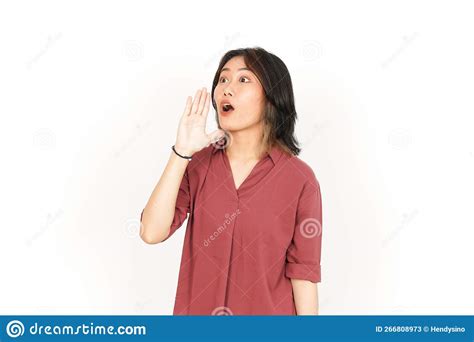 shouting out loud with hands over mouth of beautiful asian woman isolated on white background