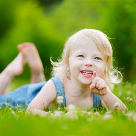 Cute Little Toddler Girl Laying In The Grass Stock Photo Image 48392472