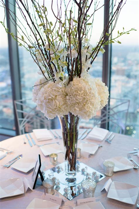 Make sure to choose your flowers wisely since they need to stand out while being limited in quantity. tall wedding centerpiece with hydrangeas and orchids ...