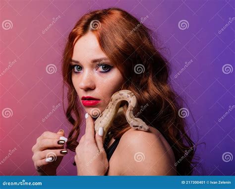 Beautiful Young Redhead Woman With A Snake With A Fashionable Perfect