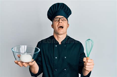 Handsome Young Man Holding Bread Dough And Blender Angry And Mad