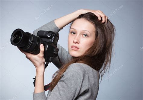 Unusual Portrait Of Beautiful Female Photographer Shooting Stock Photo