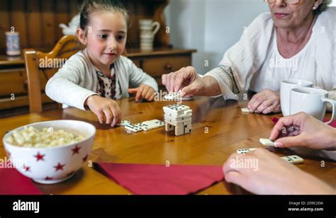 Three Female Generations Playing With Dominoes Stock Photo Alamy