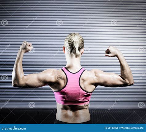 Composite Image Of Muscular Woman Flexing Her Arms Stock Photo Image