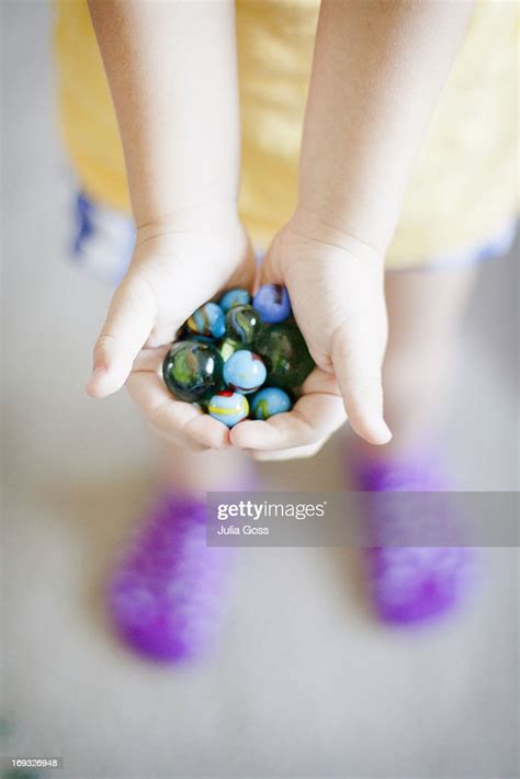 Girl Holding Marbles In Her Hands High Res Stock Photo Getty Images
