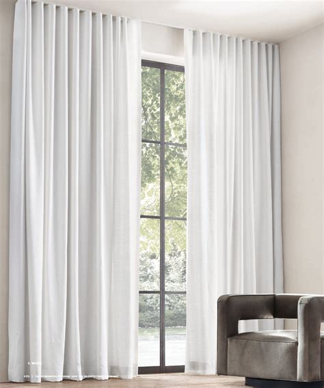 Contemporary drapes or curtains can help to lengthen a wall, make windows feel taller, and add a splash of color to keep a room from feeling too sterile. RH Source Books