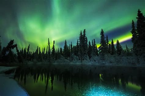 The Aurora Reflects In The Clearwater River In Delta Junction Alaska