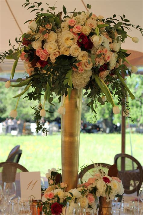 Some Of The Centerpieces Will Be Tall Clear Vases Topped With A Large
