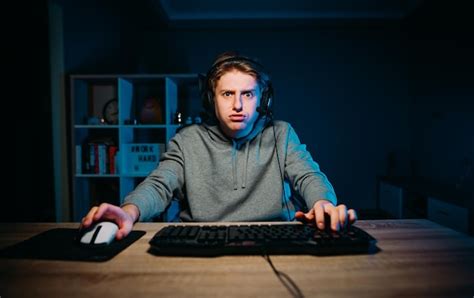 Premium Photo A Focused Gamer With A Tense Face Plays Video Games At