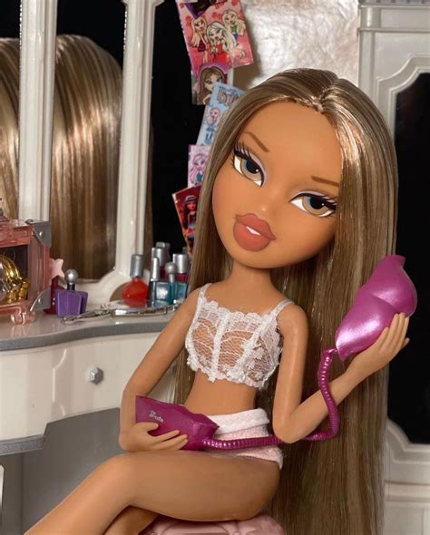 A Close Up Of A Barbie Doll Sitting On A Table With A Hair Dryer