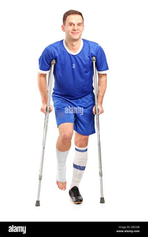 Full Length Portrait Of An Injured Soccer Football Player On Crutches