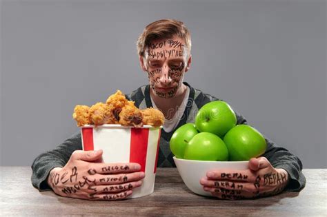 The Problem Of Choosing Good Or Bad Food Stock Photo Image Of Young